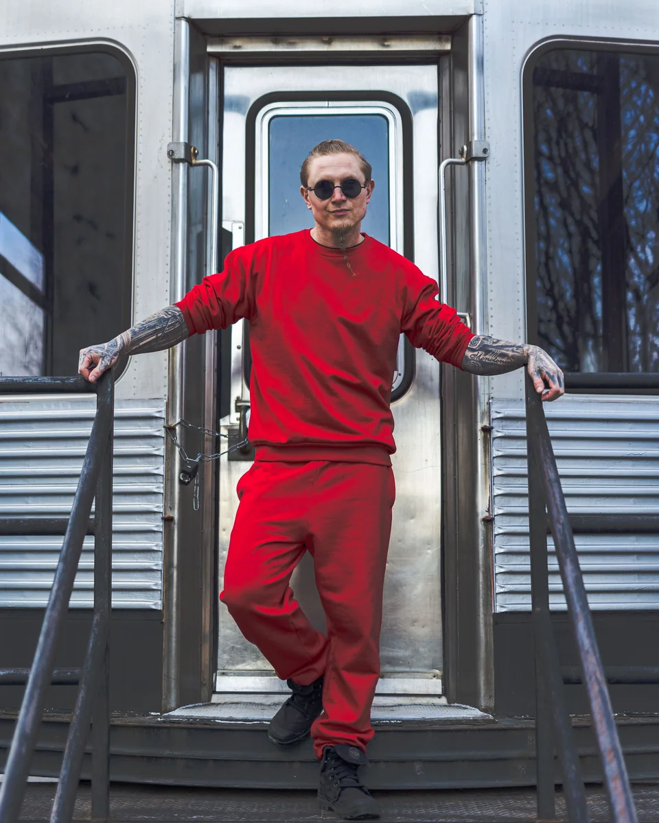 Model wearing a red crewneck sweatshirt and jogger sweatsuit set