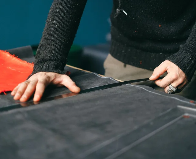 Pattern being measured and marked on fabric at a Sale Smart Sports cutting table