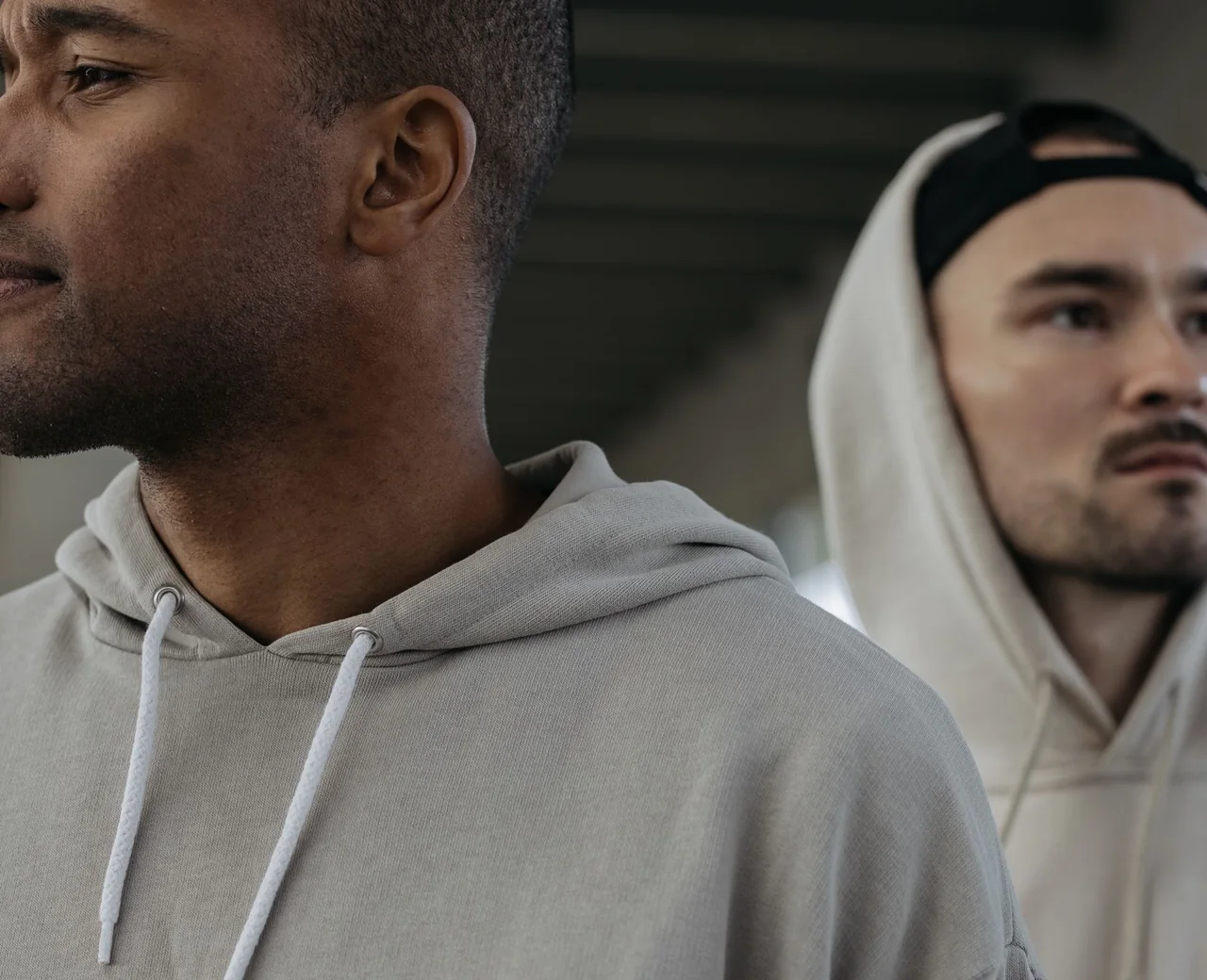 Two models wearing blank streetwear hoodies made by Sale Smart Sports