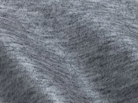 Close-up of soft grey heather fleece fabric used for hoodie bodies