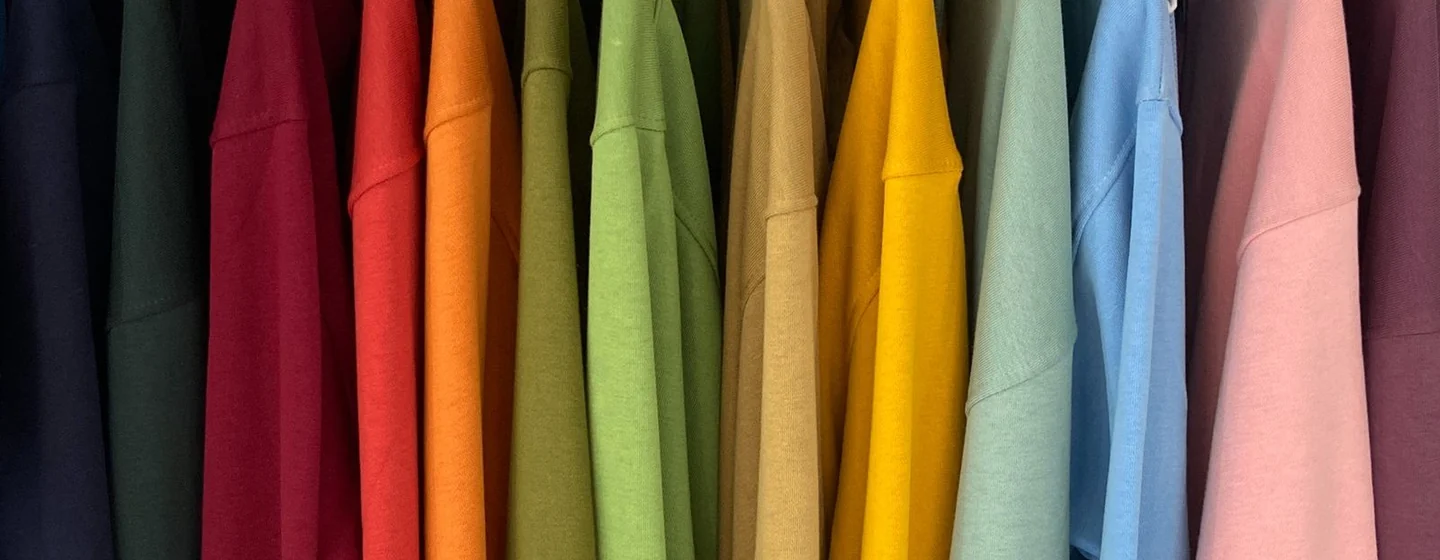 Row of hoodies in many colors hanging on a rail, ready for color selection