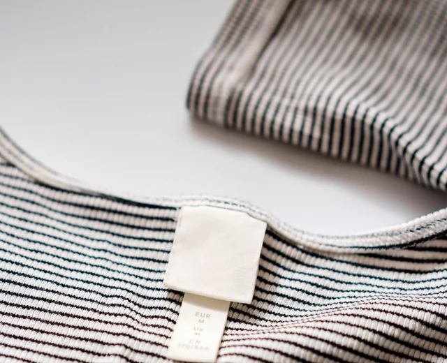 Blank neck label inside a striped t-shirt, ready for private label branding